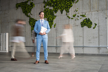 Businessman standing focused with world map background
