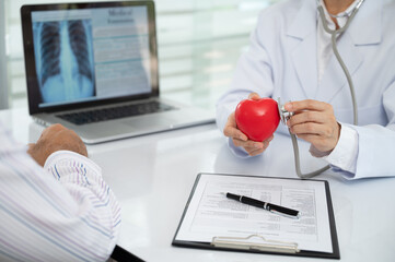 Cardiologist doctor using stethoscope for checkup heart disease at cardiology center. medical heart care concept.