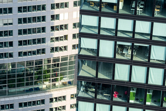 Urban office glass facade with windows reflection and pattern in frankfurt germany showing modern architecture detail and city building texture