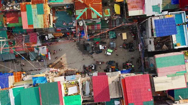 Cinematic Drone Rise Over Tondo Happyland Street Where Youth Play At Sunset