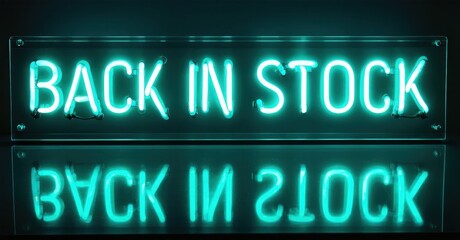 Fototapeta premium Bright neon sign displays back in stock message. Reflection visible below, creating symmetrical visual effect. Dark background enhances glow.