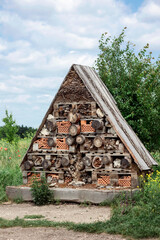 Bug Hotel or Insect House in Green Field. Handmade Attract Bug Hotel Guests.