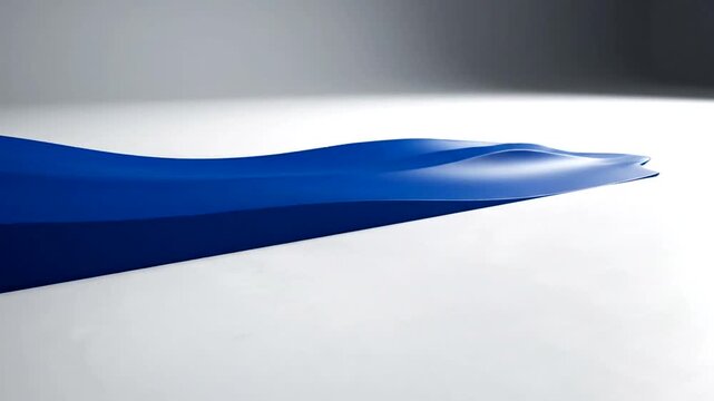 Deep blue fabric folds form an abstract wave or dune shape