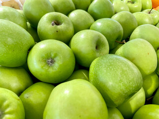 piles of fresh green apples on the fruit market shelves with various type granny smith mutsu Reinette Simirenko apel malang
