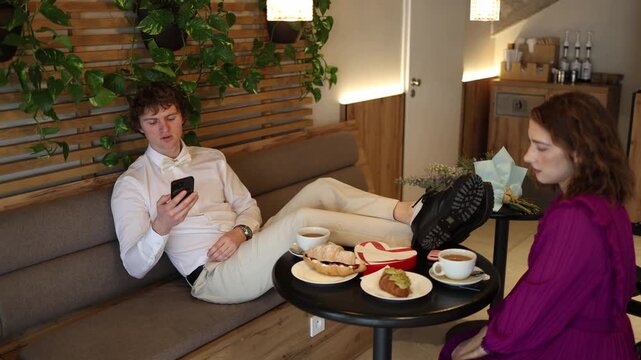 Toxic date moment as the guy talks on his phone with feet on the table while the girl looks disappointed on valentines day valentine day valentinesday