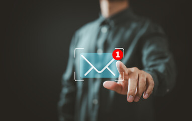 Businessman interacting with virtual email notification symbol and new message alert