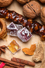 Turkish delight cubes and churchkhela with walnuts and cinnamon in Christmas setting