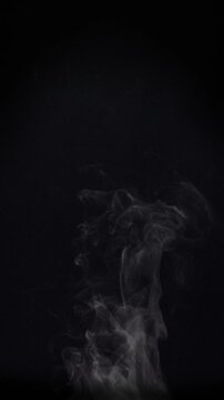White natural rising steam from food or hot drink isolated on a black background. Сan be used in any projects with hot food.