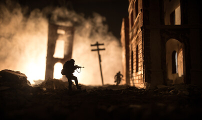 Fototapeta premium War Concept. Battle scene on war fog sky background, Fighting silhouettes Below Cloudy Skyline at night. City destroyed by war
