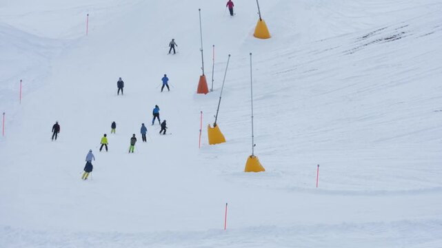 Group of skiers skiing down mountain slope in winter in davos klosters