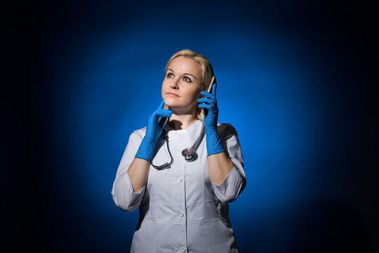 woman doctor thinking takes a phone call