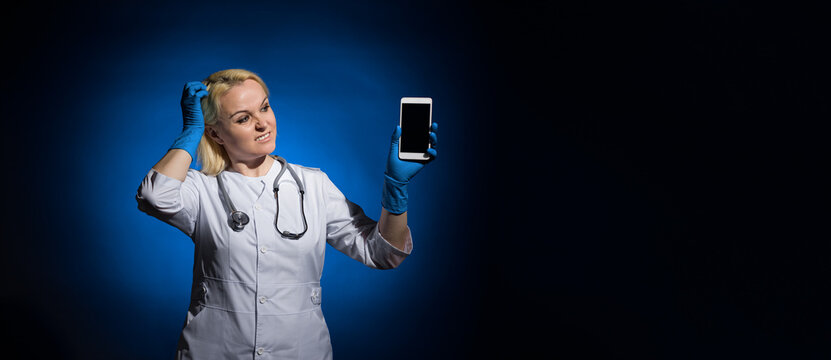 female doctor looks at the phone and does not want to pick up the phone