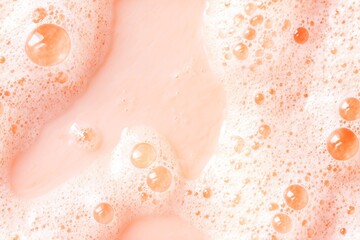 Fototapeta premium Pink soap bubble natural surface as abstract cosmetic background. Cleansing foam texture pattern for beauty, spa, hygiene product.