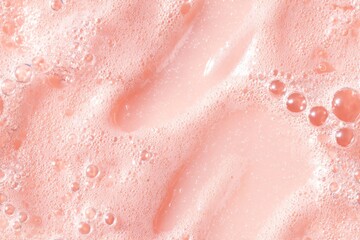 Fototapeta premium Pink foam with bubbles abstract texture background close up. Cosmetic cleansing product fluid with air bubbles. Background for beauty, cosmetic product display.