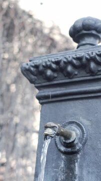 : close up of funtain in Italian lake Garda with blurred mountain in the background
