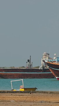 Traditional Dhow old wooden boat in the harbor of Iranian Qeshm Island. Tradition Lenj Fishing Boat in Qeshm Island in Southern Iran. Old wooden stealth smuggler's ship.