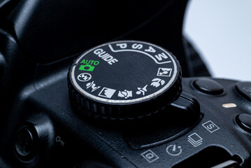 digital camera mode dial displaying auto, manual, program, shutter priority, aperture priority, and guide modes.