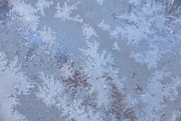 Frost Patterns on Glass, Frozen Winter Texture Background. Abstract frost patterns formed on frozen glass surface. Delicate ice crystals create a natural winter texture with cool tones. 