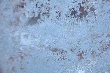 Soft Frost Patterns on Glass, Minimal Winter Ice Background. Soft frost patterns naturally formed on glass create a calm and minimal winter texture. 