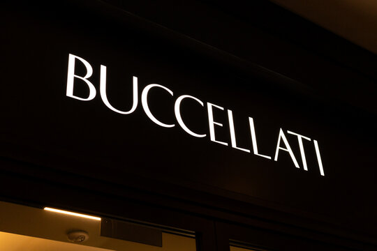 Singapore - January 27, 2026: The entrance to Buccellati in Singapore features a bright store sign. Passersby can see the high-end jewelry displayed inside. It is evening, and the store lights