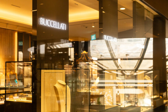 Singapore - January 27, 2026: In Singapore, the Buccellati store displays fine jewelry through glass cases. Natural light illuminates the elegant pieces. Shoppers view the collections inside store.