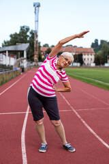 Obraz premium Woman running in the stadium. Sports exercises, warm-up
