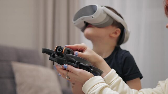 Young caucasian child exploring vr while holding drone robor.