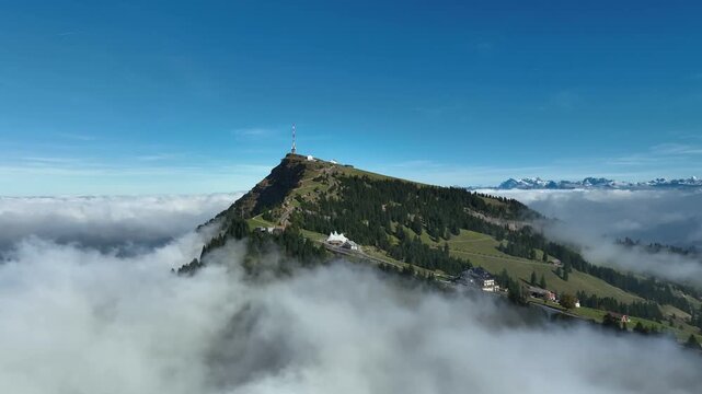 Aerial view of Rigi Kulm mountain peak rising above coud layer