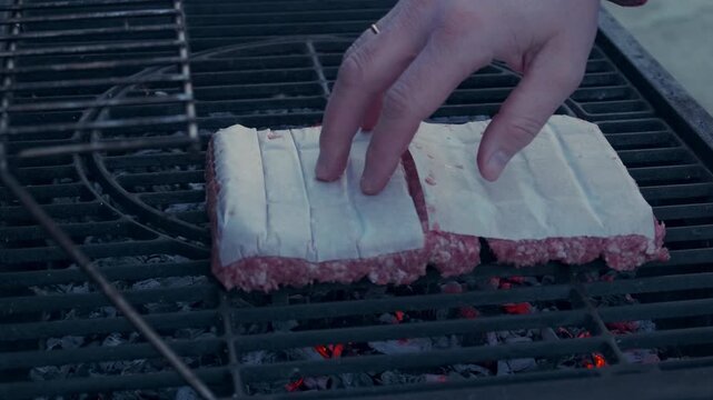 Preparing traditional food Mici on grill outdoors