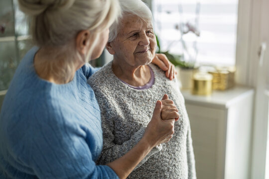 Elderly woman with her caregiver in a nursing home
