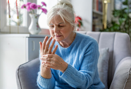 Senior woman suffering from pain in her hand

