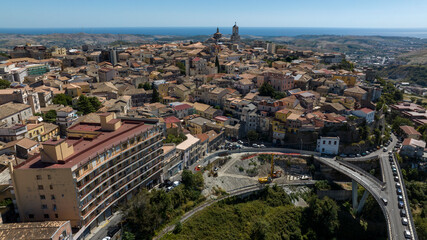 Obraz premium Aerial view of the historic center of Catanzaro, Italy. This city is the capital of the Calabria region. On the horizon, the Ionian Sea and a clear sky.