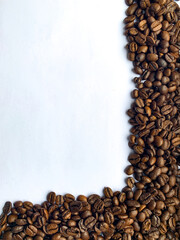 coffee beans and roasted coffee beans on white paper.