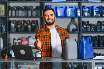 Auto parts store worker offering handshake for service