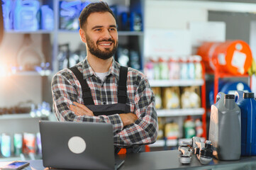 Auto mechanic smiling standing at service desk