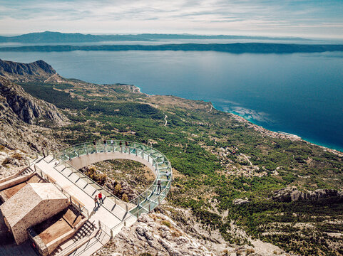 Aerial view of the Biokovo Skywalk's glass platform clinging to the rugged mountain, offering breathtaking views of the Adriatic Sea, Biokovo, Splitsko-dalmatinska &Aring;&frac34;upanija, Croatia.