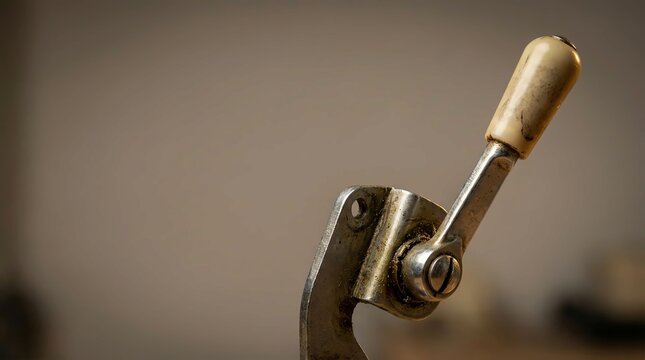 Vintage metal lever mechanism with aged ivory handle detail close up shot