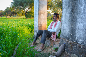 Fototapeta premium Portrait of rural indian farmer outside traditional village home