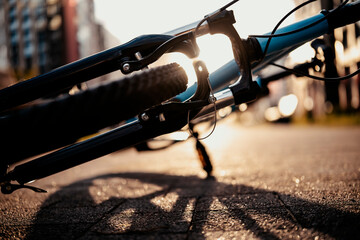 Close up of bicycle fork and wheel laying on ground. Technical maintenance and safety check before ride.