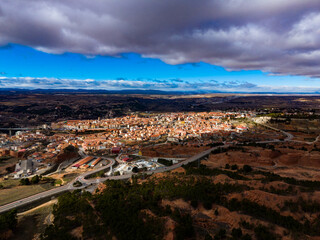 Obraz premium View of Teruel from a high point showing the city layout and surrounding landscape during daytime with clouds in the sky