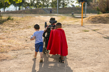 Children playing, helping friend in wheelchair