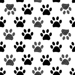 Fototapeta premium Black paw prints made of polka dots. Seamless fabric design pattern