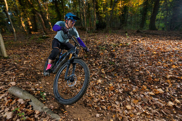 Autumn Forest Mountain Bike Rider Navigates Leaf-Litter Trail with Speed and Focus