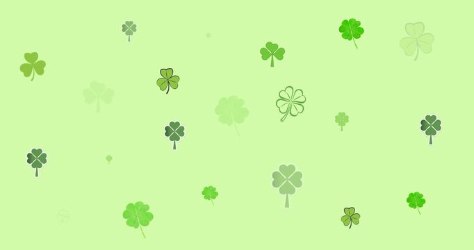 Digital animation of multiple clover leaves forming against green background