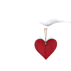 A red heart-shaped ornament with a dove flying above it on a black background