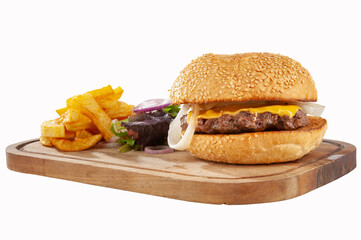 Hamburger with potatoes and vegetables on a wooden board