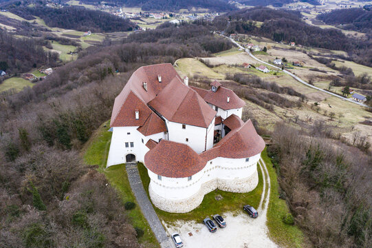 Aerial view of the imposing Veliki Tabor castle with its distinctive red roofs and stark white walls amidst the surrounding landscape, Desinic, Krapinsko-zagorska zupanija, Croatia.