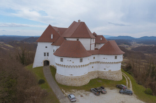Aerial view of the historic Veliki Tabor castle with its red-tiled roofs and stark white walls atop a hill, Desinic, Krapinsko-zagorska zupanija, Croatia.