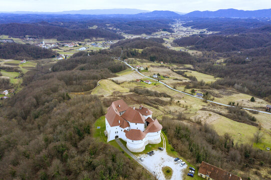Aerial view of Veliki Tabor Castle's red roof contrasting against the surrounding landscape, a testament to history and architectural brilliance, Desinic, Krapinsko-zagorska zupanija, Croatia.
