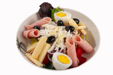 Salad with ham, tomatoes, eggs, olives, yellow cheese and onion